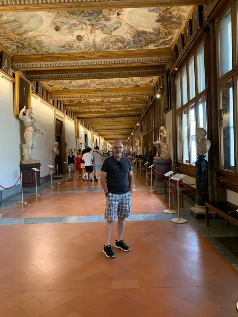No 3 day florence itinerary is complete without Ufizzi Gallery. Nusi standing in the hallway at the amazing Uffizi Gallery in Florence. 